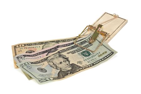 Money caught in a mouse trap on a white backgroundの写真素材