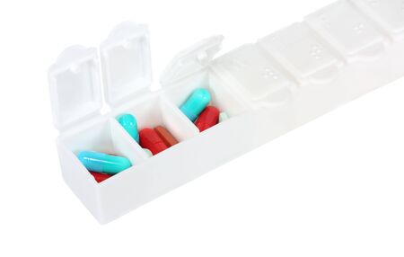 Pill box with pills isolated on white