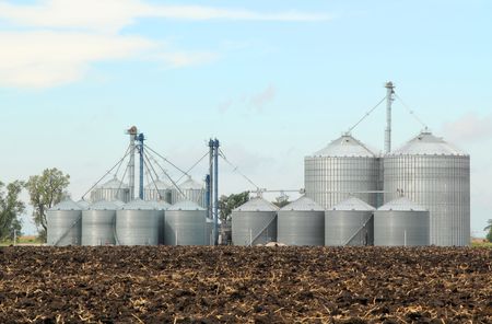 Agricultural grain bins in a farm fieldの写真素材