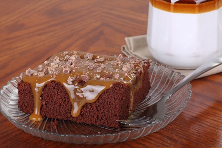 Piece of chocolate cake topped with butterscotch sauceの写真素材