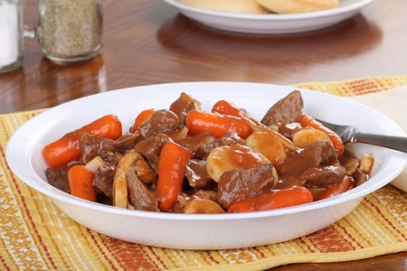 Beef stew with carrots and potatoes on a plateの写真素材