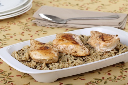 Baked chicken breasts with rice in a serving platterの写真素材