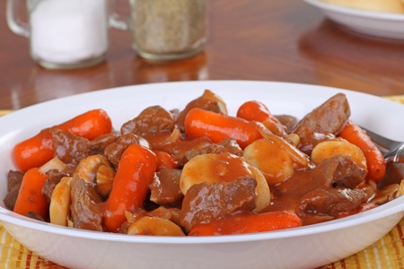 Plate of beef stew with carrots and potatoesの写真素材