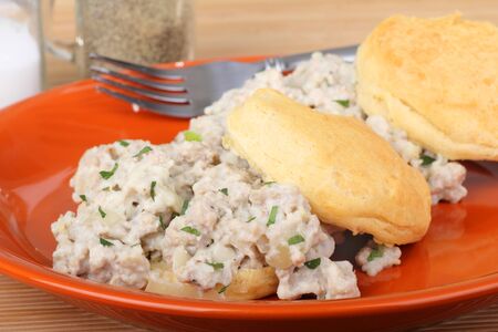 Sausage gravy on top of biscuits on a plateの写真素材