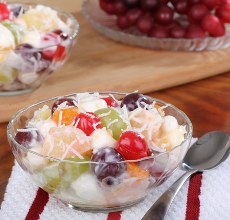Fruit salad with cherries, grapes, and pineapple in a bowlの写真素材