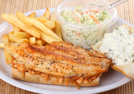 Carfish fillet sandwich with french fries and coleslawの写真素材