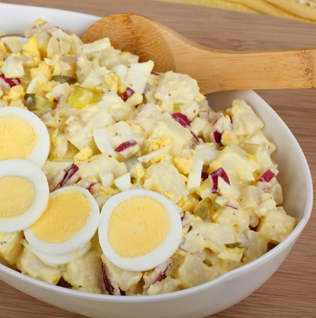 Potato salad with sliced eggs in a serving bowlの写真素材