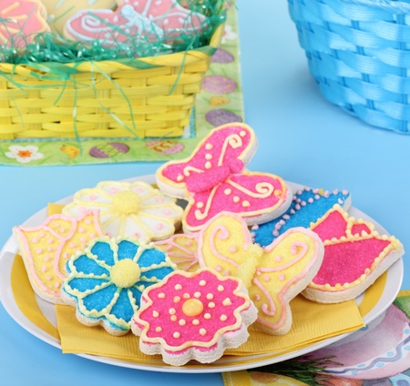 Flower and butterfly cookies with easter baskets in background