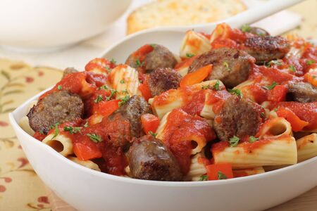 Rigatoni pasta with sliced bratwurst in a bowlの写真素材