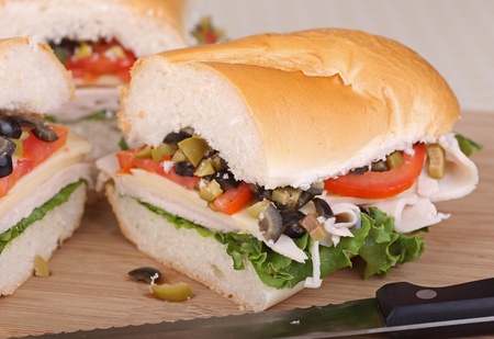 Sandwich with turkey, lettuce, tomato and olives on french breadの写真素材