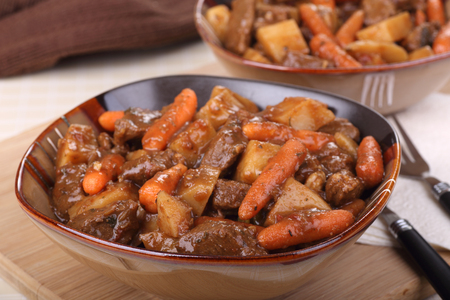 Bowl of beef stew with carrots and potatoesの写真素材