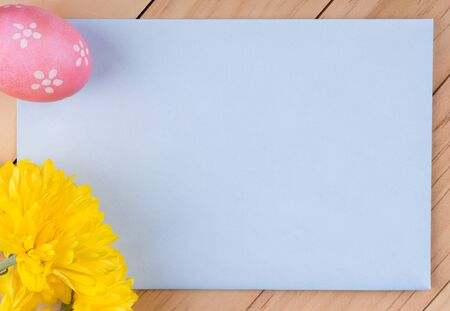 Blank envelope with decorated Easter egg and flowerの写真素材