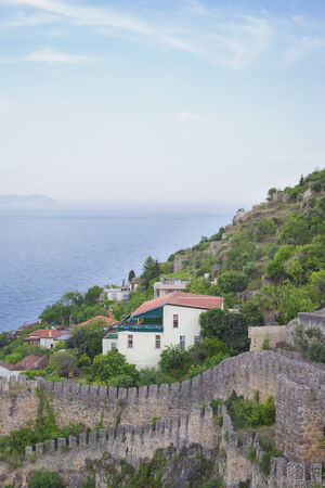 View of the castle Kizilkule and the sea with the mountains in Alanyaのeditorial素材