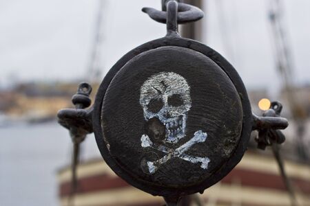 Pirate label. The skull and crossbones painted on the side of the mast of the shipの写真素材