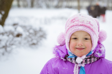 Cheerful little girl playing with snow in winter snowy Park, Krasnoe Selo, Saint-Petersburg, Russiaの写真素材