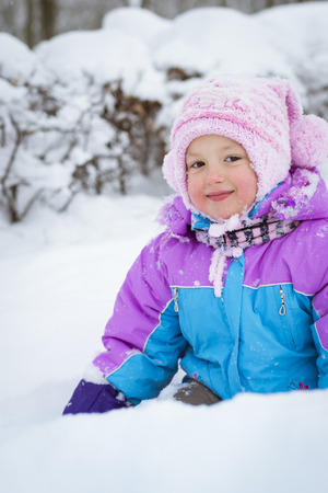 Cheerful little girl playing with snow in winter snowy Park, Krasnoe Selo, Saint-Petersburg, Russiaの写真素材
