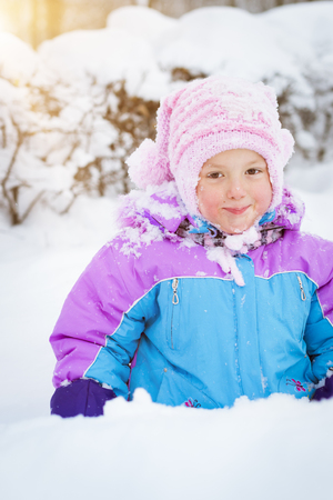 Cheerful little girl playing with snow in winter snowy Park, Krasnoe Selo, Saint-Petersburg, Russiaの写真素材