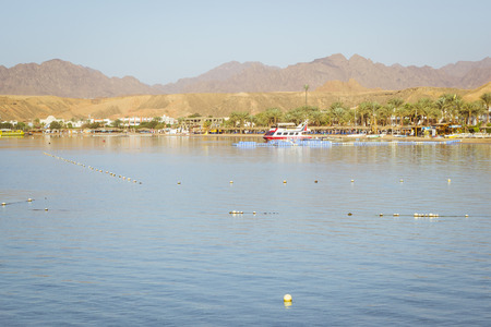 SHARM EL SHEIKH, EGYPT - FEBRUARY 22, 2014: February day on the beach in Sharm-El-Sheikh, the red...