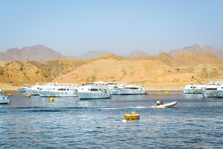 SHARM EL SHEIKH, EGYPT - FEBRUARY 25, 2014: Marina: Pleasure sightseeing boats on the Parking lot of boat Park, boat trip for tourists, Sharm El Sheikh, Egyptのeditorial素材
