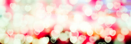 Valentine's Day Abstract blurred background with bokeh of hearts. The substrate for holiday greeting...