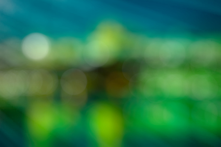 Bright abstract background in shades of green with bokeh. Festive substrate for holiday textの写真素材