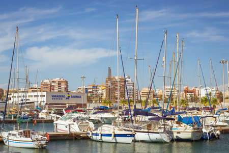 TORREVIEJA, SPAIN - SEPTEMBER 13, 2014: Puerto deportivo Marina Salinas. Yachts and boats parked at dock in Marina of Torrevieja. Bay with piers in centre of resort town. Valencia, Spainのeditorial素材