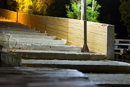 Old street concrete stairs, illuminated by road lights. Dark quiet lonely night in resort mediterranean village. Bali, Rethymno, Crete, Greeceの写真素材