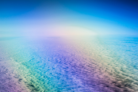 Airplane flying above cumulus clouds. View of sky from aircraft, long distance travel by airtransport. Russian airlinesの写真素材
