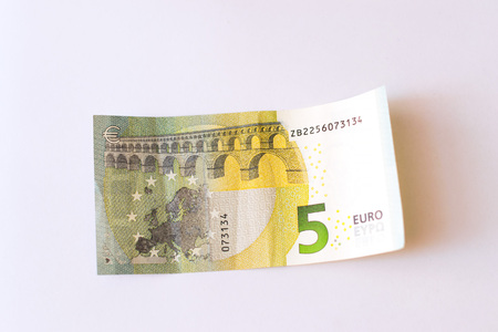 Euro banknotes are in denominations of 5 euros. Symbol of European currency to wealth and...