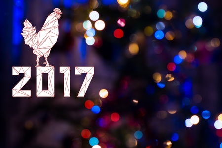 2017 with Cock on festive Christmas background with bokeh from New-year tree lights glowing. Rooster is symbol of New 2017 year of red fiery cock. Blurred colorful circles on holiday backgroundの写真素材