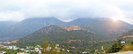 Mountainous nature of resort village Bali on island Crete in Greece. Low dark clouds hide tops of mountains, morning cool and fog on hilly plateau. Rethymno, Crete, Greeceの写真素材