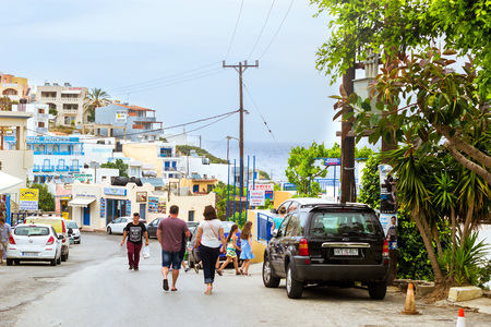 Bali, Greece - April 30, 2016: Modern and classic resort Greek architecture, white-blue buildings stands on shore of Cretan sea. Tourists walking around city, visiting sights and souvenir shops. Resort village Bali, Rethymno, Crete, Greeceのeditorial素材