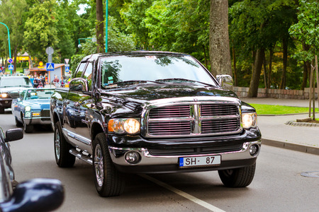 Palanga, Lithuania - August 11, 2012: Parade of old classic and modern American cars doodge on main...