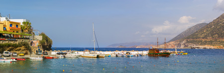 Bali, Greece - April 30, 2016: Harbour with marine vessels, boats and lighthouse. Sea view at bay. Bali is vacation destination resort, with secluded beaches. Rethymno, Crete, Greeceのeditorial素材
