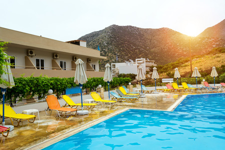 Bali, Greece - May 2, 2016: Relax and sunbathe by pool with clear blue water in Resort hotel Atali Village, 4 star. Empty pool without tourists early morning at hotel. Bali, Rethymno, Crete, Greeceのeditorial素材