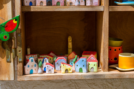 Rethymno, Greece - May 3, 2016: Handmade souvenir clay houses in  window of tourist resort store. Resort classic Greek architecture in port-city Rethymno. Crete, Greeceの写真素材