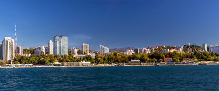 View from water during boat trip at architecture of modern resort town Sochi, hotels, sanatoriums,...