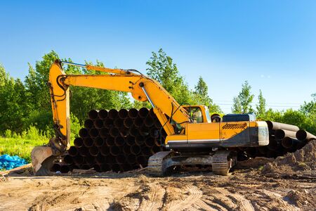 Crawler Excavator digging bucket on construction of high-speed ring road around Krasnoe Selo, Saint...
