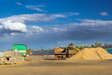 Heavy empty truck is waiting for loading of gravel. Construction of high-speed bypass road around...