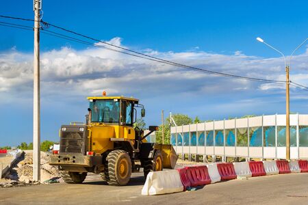 Bulldozer with bucket on construction of high-speed bypass road around Krasnoe Selo, Saint...