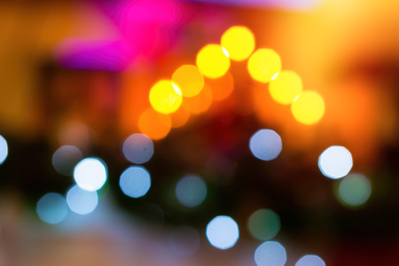 Festive New-year background with bokeh from Christmas tree lights glowing. Blurred colorful circles...
