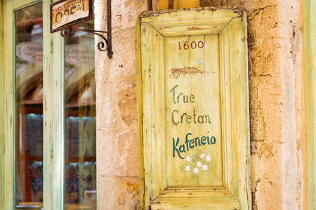 Rethymno, Greece - May 3, 2016: Decorated street advertising signboard on narrow touristic street in tourist routes. Walk around old resort town Rethymno in Greece. Mediterranean architecture on Creteのeditorial素材