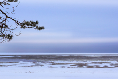 Winter day on snowy shore of Narva Bay. Snow on the ice of the frozen Gulf of Finland. Narva-Joesuu resort town in North-East of Estonia in Ida-Virumaa County. Severe Northern winter and snowy weatherの写真素材