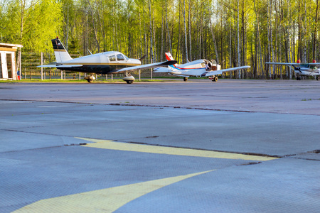 Light passenger planes parked before departure at private airport in Kronshtadt, St.Petersburg,...
