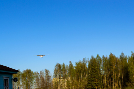 Light passenger plane lands at a private airport, Kronshtadt, St. Petersburg, Russia. Professional flights on airplanes. Industrial and civil air transportation by aircraftの写真素材