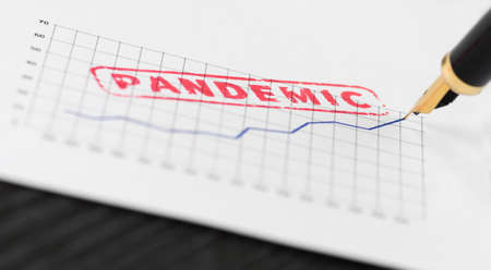 Seal pandemic stamped on a graph, increasing trend and fountain pen. Macro shot.