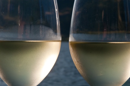 Closeup abstract of two glasses of white wine with condensation on the outside of themの写真素材