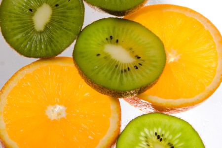 Background of citrus fruits. Slices of orange and kiwi, isolated on white background. Healthy style of life. Fitness.の写真素材
