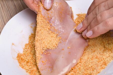 Preparing cutlets from the chicken . Chicken coated in breadcrumbs.