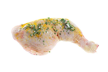 Fresh chicken drumstick with curry powder ready to be grilled on white backgroundの写真素材